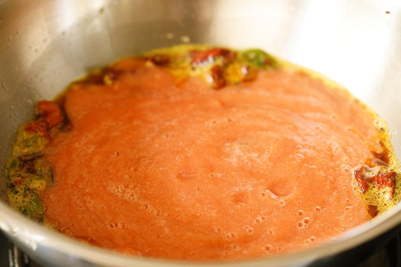 tomato puree in pan.