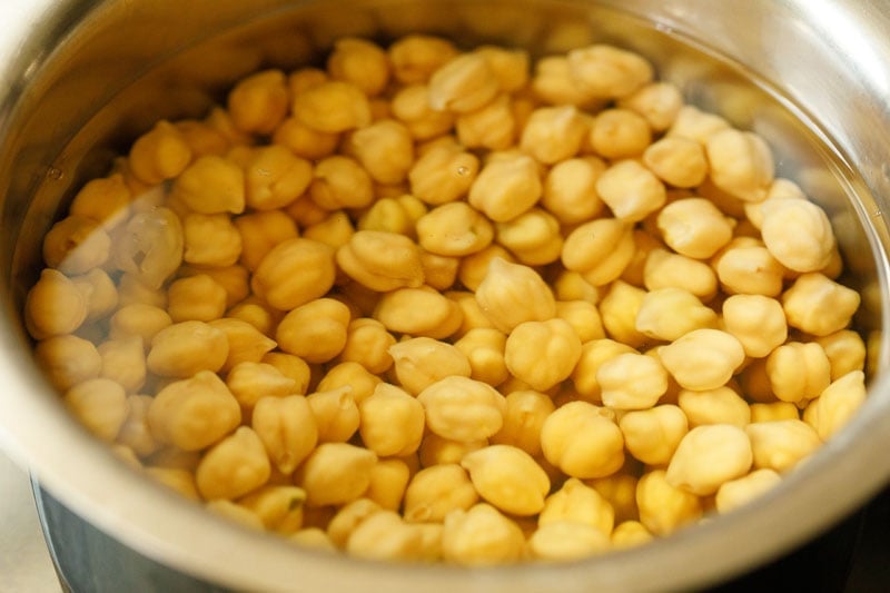 soaking chickpeas in water for mediterranean chickpea salad. 