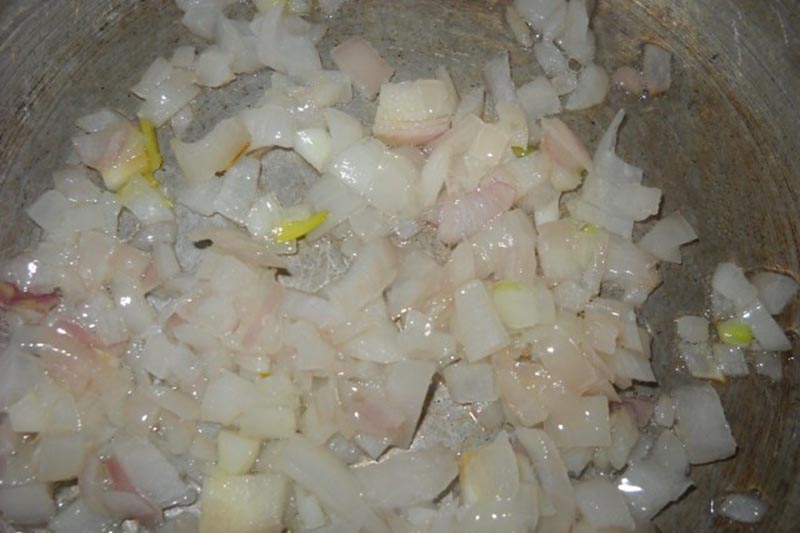 sautéing chopped onions in hot oil in another pan.