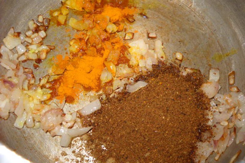 turmeric powder and malvani masala added to the frying onions.