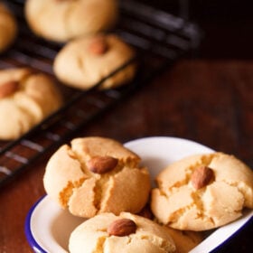 three nankhatai in a square white bowl.