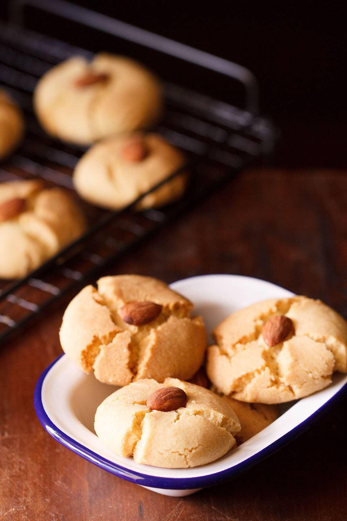 three nankhatai in a square white bowl.