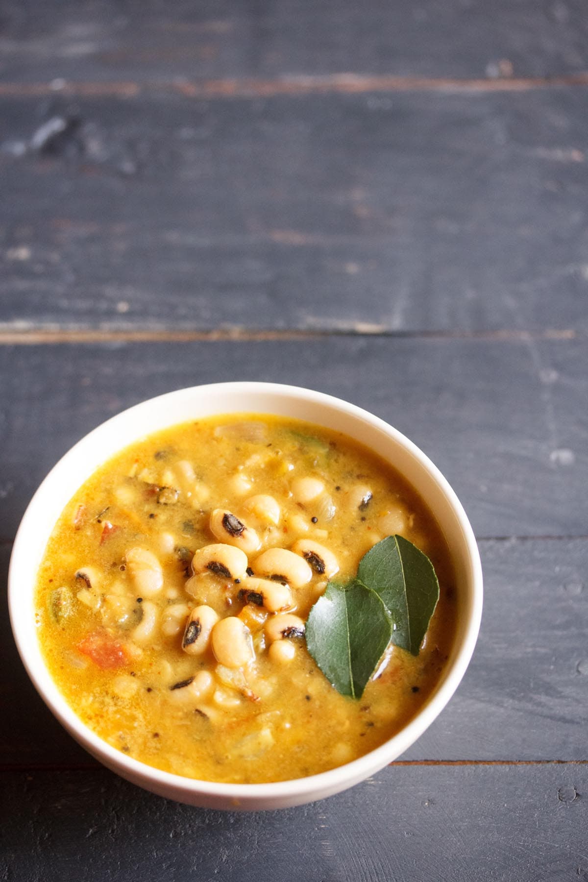 black eyed peas curry in an off-white bowl.