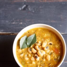 black eyed peas curry in an off-white bowl.