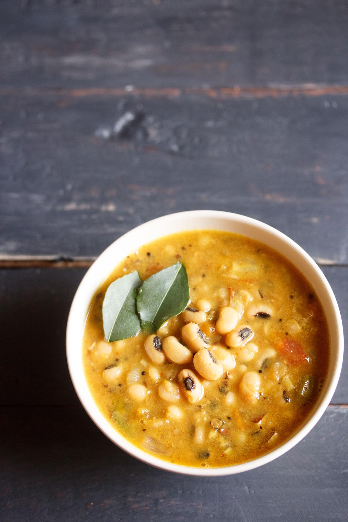 black eyed peas curry in an off-white bowl.