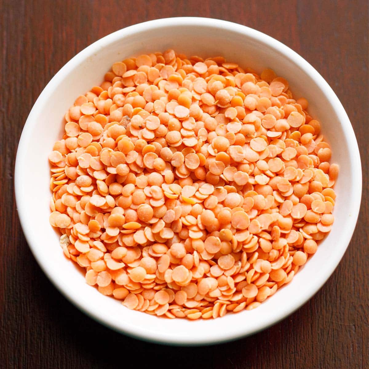 masoor dal or red lentils in a white bowl.