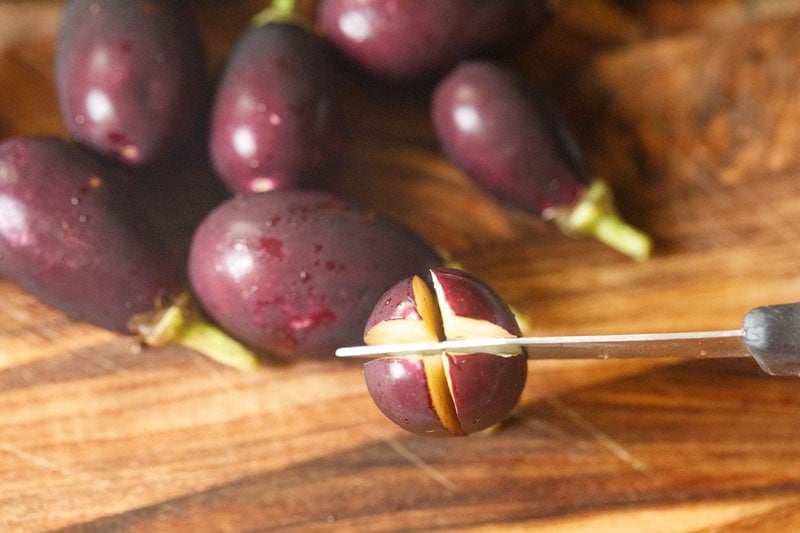 cutting small brinjals. 