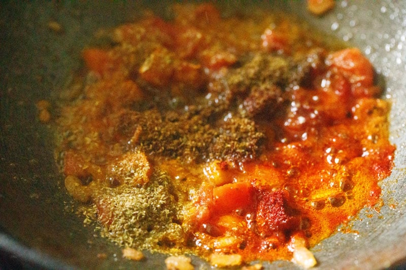 ground spices added to softened tomatoes.
