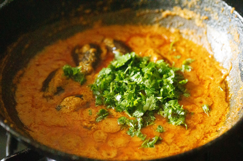 chopped coriander leaves on top of the bharli vangi curry.