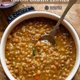 whole masoor dal served in a bowl with a spoon in it and text layovers.