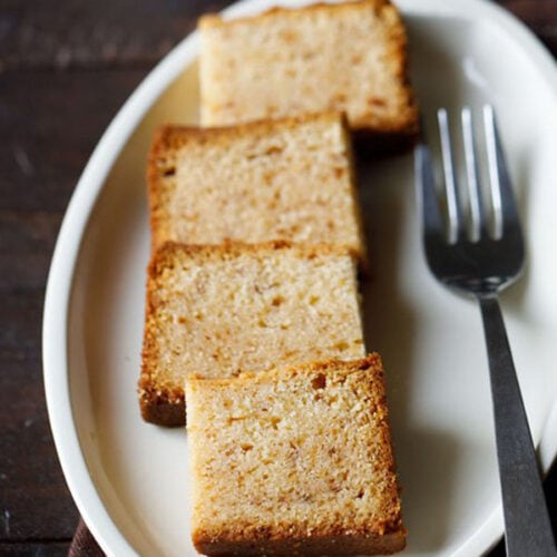 butter cake squares on white plate with fork by the side.