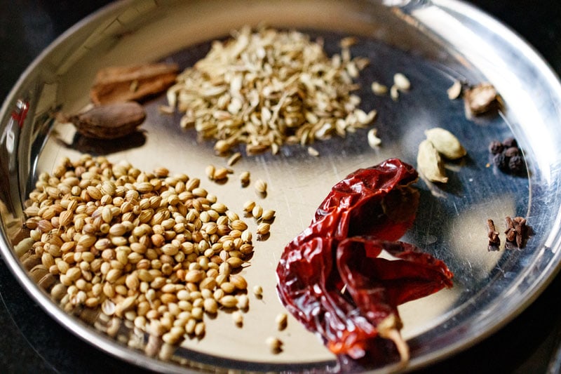 spices in a steel plate to make chickpea curry. 