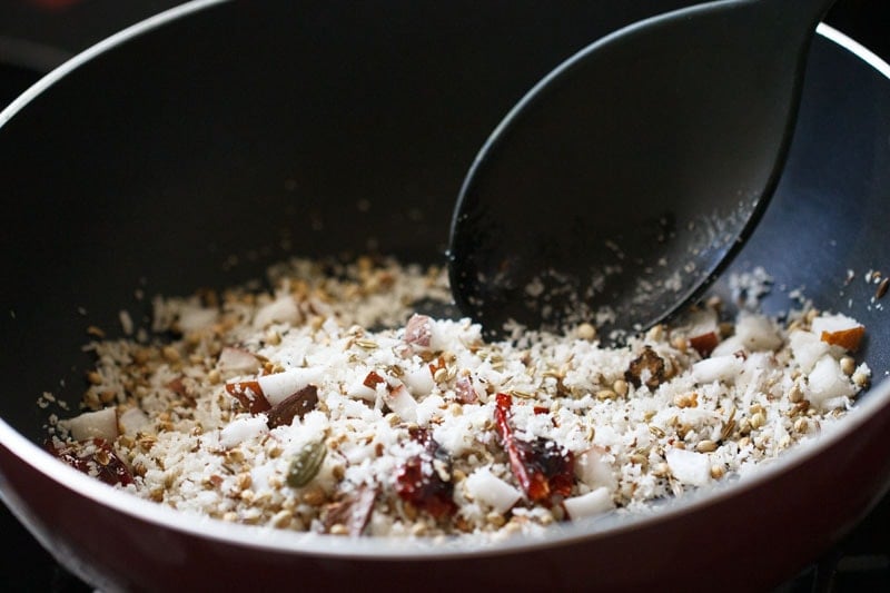 stirring the coconut while toasting or roasting. 