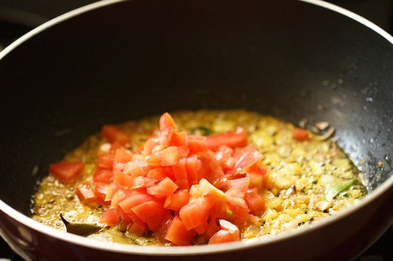 chopped tomatoes added in the pan. 