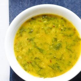 dal palak in a white bowl.