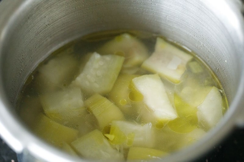 softened lauki in cooker with stock.