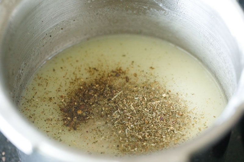 dry herbs and crushed black pepper on top of the bottle gourd soup.