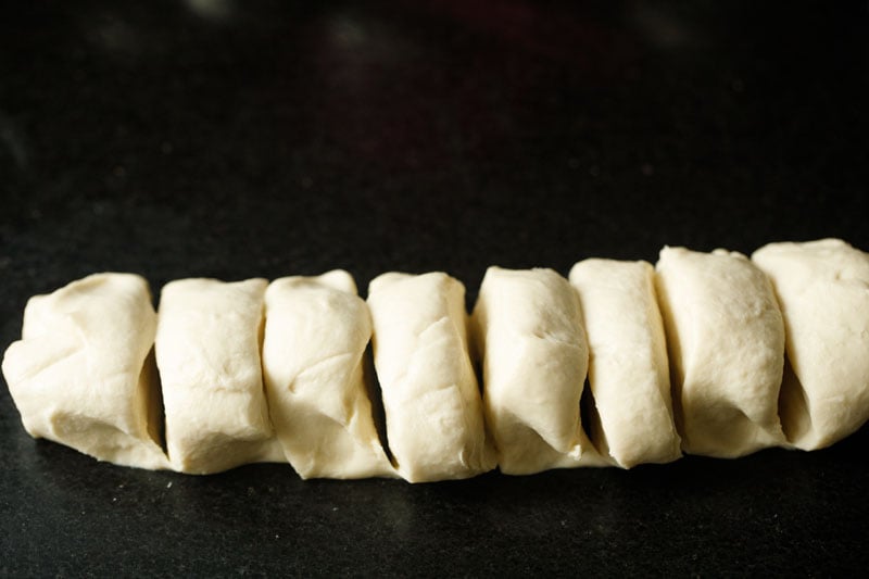 prepared dough portioned into 8 parts for making kerala paratha.