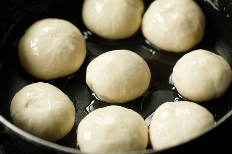 dough balls kept in the bowl and oil poured over them for making kerala paratha.
