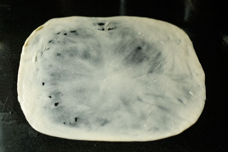 dough flattened into a thin rectangle for parotta recipe. 