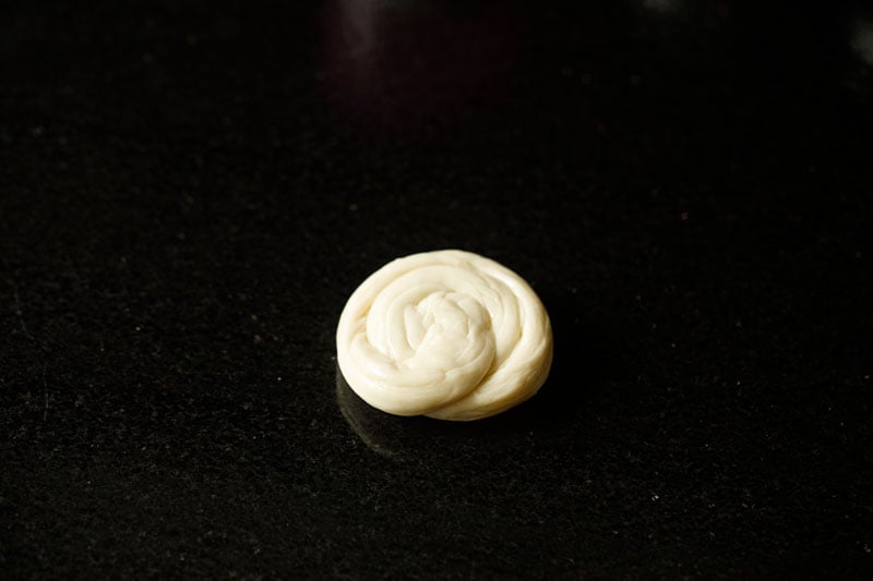 edges brought together and shaped into a spiral shaped roll for parotta recipe. 