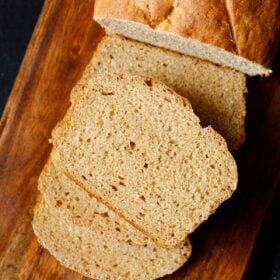 whole wheat bread slices on wooden board.