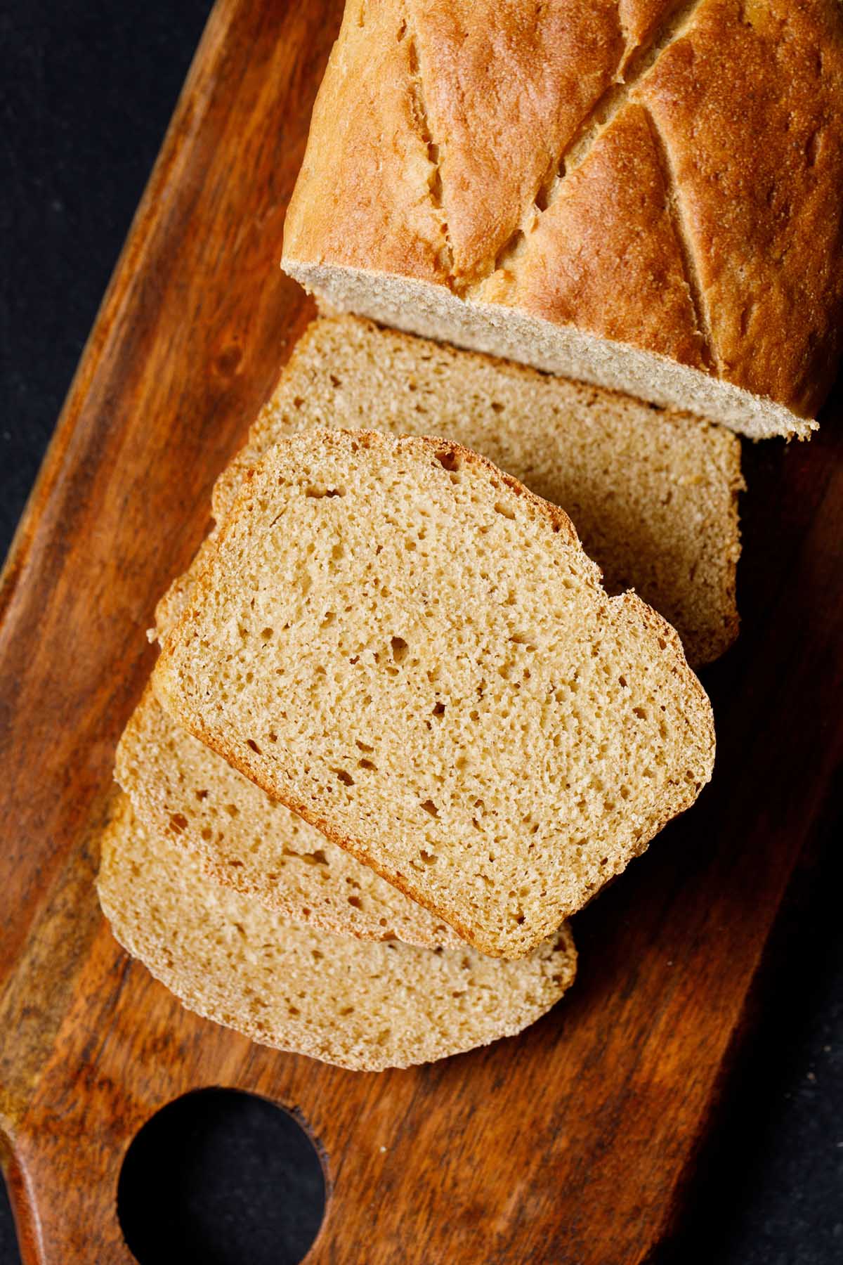 whole wheat bread slices on wooden board.