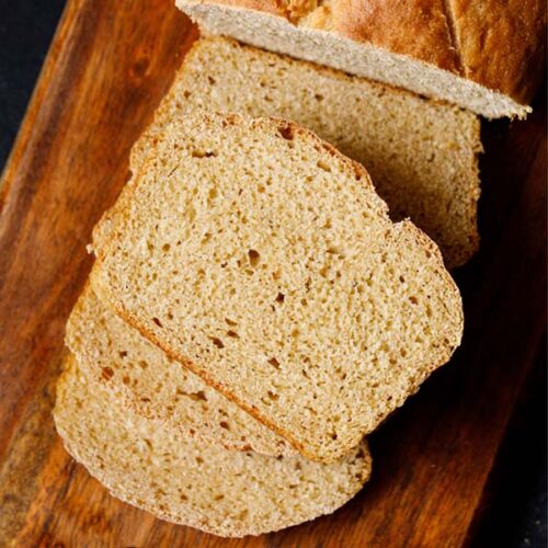 whole wheat bread slices on wooden board.