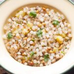closeup photo of sabudana khichdi in a cream plate.
