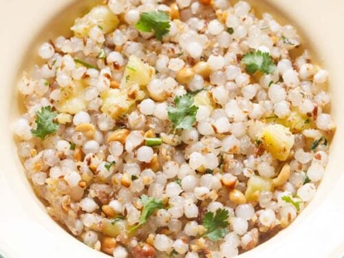 closeup photo of sabudana khichdi in a cream plate.