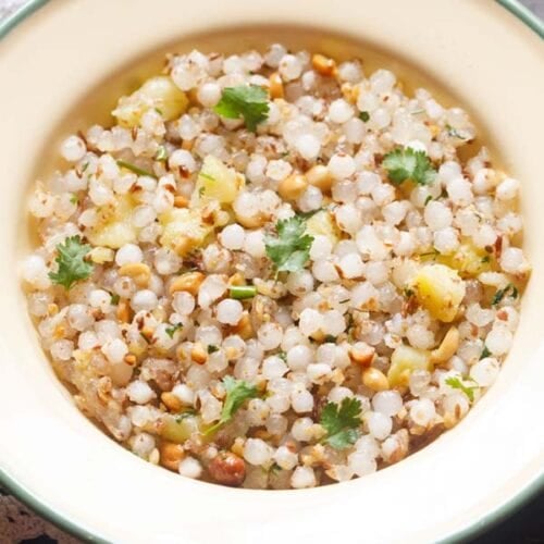 closeup photo of sabudana khichdi in a cream plate.