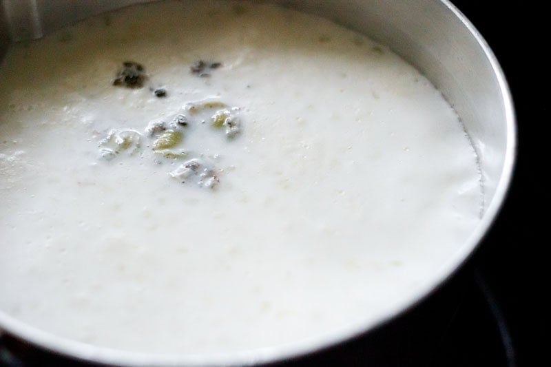 Milk and cardamom powder added to the sabudana kheer mixture.