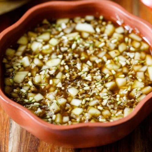 ugadi pachadi in a brown colored ceramic bowl.