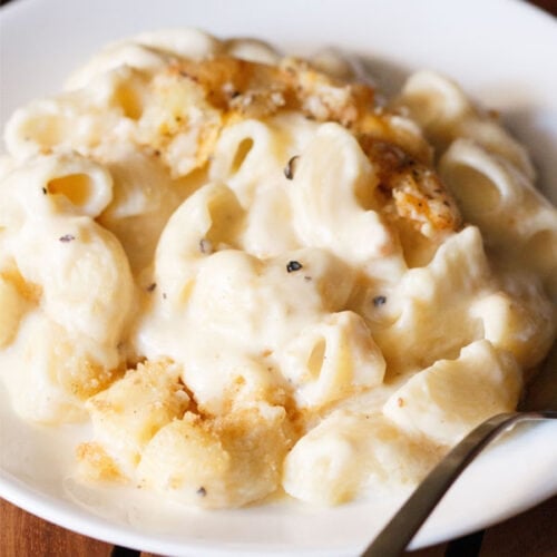 close up shot of homemade mac and cheese in a deep white plate.