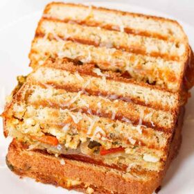 Paneer sandwich on a white plate.