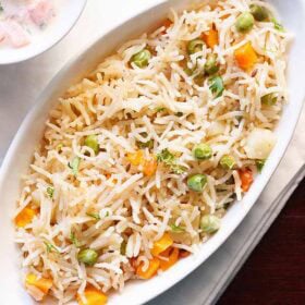 Vegetable pulao in white bowl.