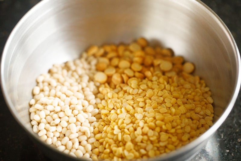 lentils added to a bowl for making paddu. 