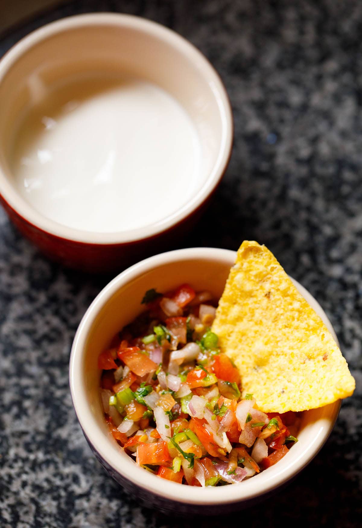 The salsa comes in a bowl with tortilla chips inside.