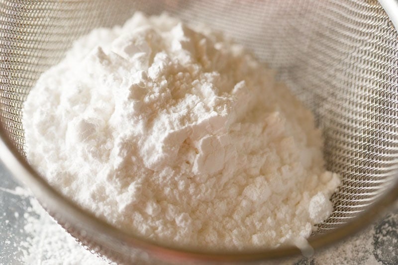 sifting powdered sugar for pinni. 