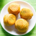 aloo bonda on a white plate.