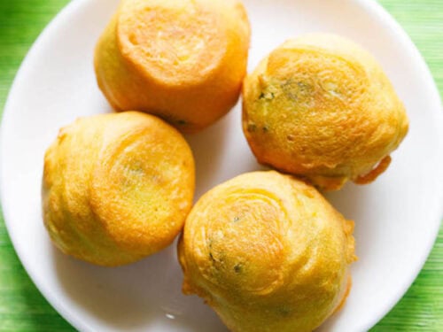 aloo bonda on a white plate.