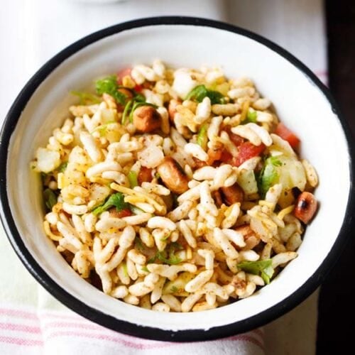 jhal muri in black rimmed white bowl.