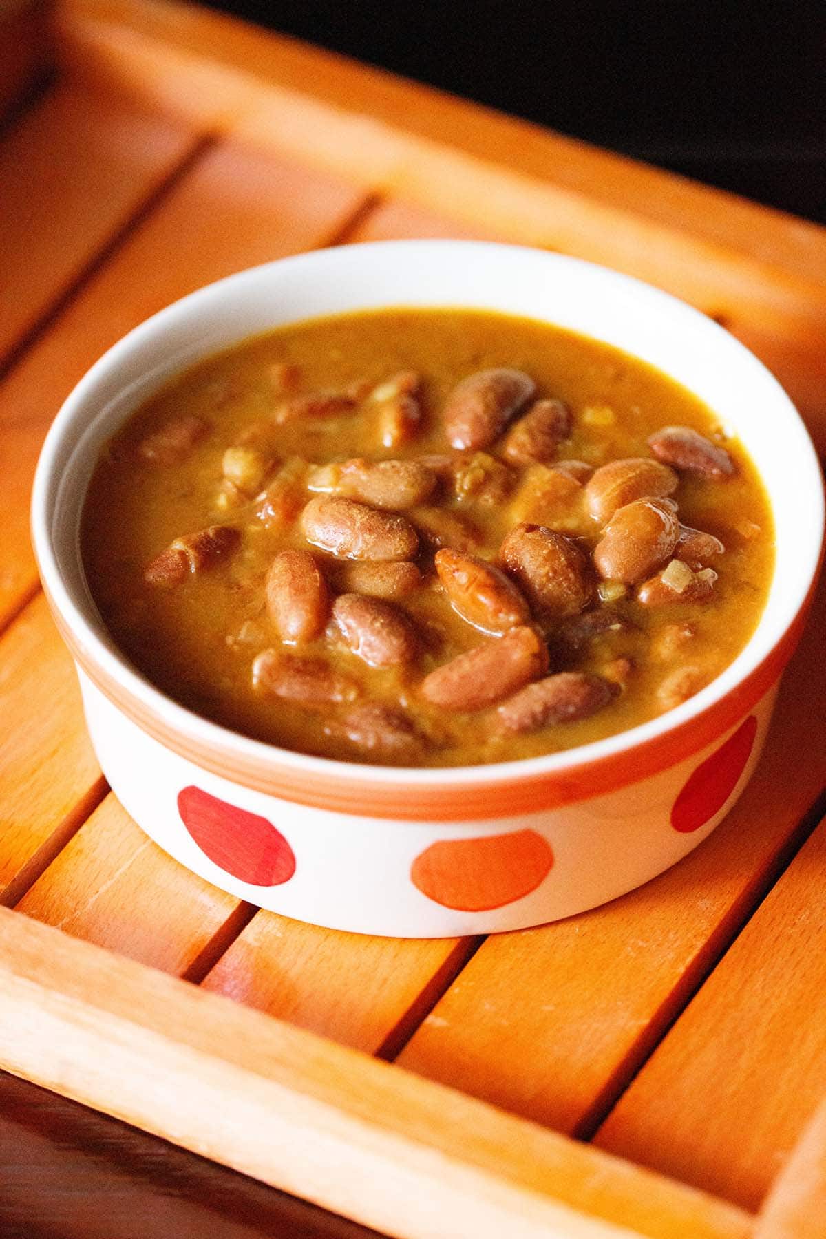 rajma curry in an orange and red dotted bowl.