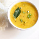 varan bhat served on a white plate.