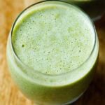 green smoothie in a round large glass.