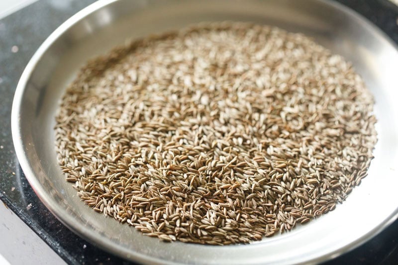 extra roasted cumin seeds on a plate for making bhuna jeera powder.