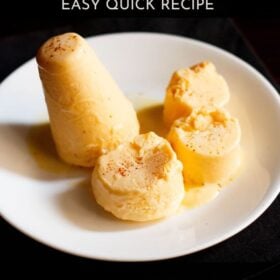 mango kulfi sliced and whole served on a white plate with text layovers.