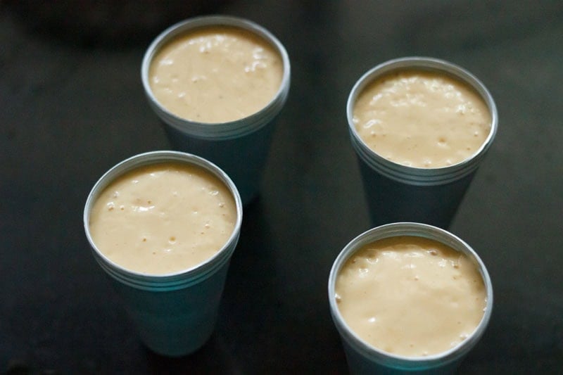 mango kulfi mixture in moulds.