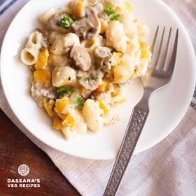 mushroom pasta served on a white plate with a fork.