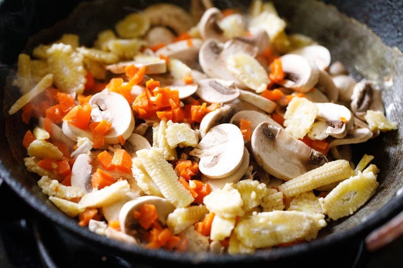 sliced mushrooms, finely chopped carrots and sliced baby corn added to pan.